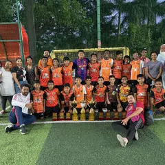 The team celebrating with all their trophies and medals after a successful Independence Cup.