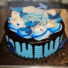 My Choco-Blueberry flavor with a beautiful butterfly theme. The blue frosting and chocolate drip are complemented by delicate, edible blue butterflies.