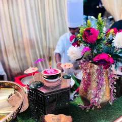 A chef preparing our signature Watermelon Ice Cream. The vibrant pink ice cream is served in a mini watermelon bowl, creating a whimsical and delicious dessert experience.