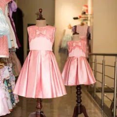 A perfect pair of pink satin dresses for sisters. I created two sizes of the same elegant design, featuring a lace bodice and pleated skirt, for a stunning matching look.