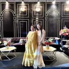 Two clients showcasing different styles. On the right, the pearl overlay sharara, and on the left, a custom ruffled gown, showing the versatility of my designs.