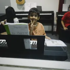 A young student proudly showing his sheet music for "Mary Had a Little Lamb". We celebrate every small victory on the path to learning an instrument.