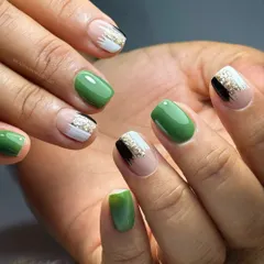 A great example of how stunning short nails can be. This set features overlays in a dark sage green with minimal, hand-painted abstract art, creating a look that is both chic and classy.