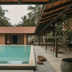 A long shot of the pool and covered patio, showing how the different wings of the villa are connected. The design prioritizes easy movement between the private rooms and the shared outdoor leisure spaces.