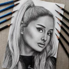 A hyper-realistic graphite portrait of Ariana Grande. I used a range of pencils from light to dark to create depth and capture a soft, yet striking expression.