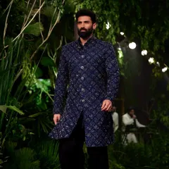 To match the raw, organic feel of Kunal Rawal's collection, I transformed the runway into a moody, primordial forest. We used giant trees and dense, wild foliage to create an environment that felt both powerful and deeply connected to nature.