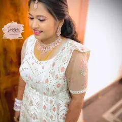 A gorgeous bride in a white and pink Anarkali for her reception. I created a fresh, dewy makeup look with a pop of pink on the lips to match her elegant outfit.