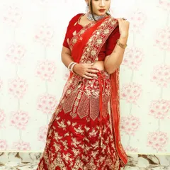 A full-length view of a maroon velvet lehenga available for rent. The skirt has extensive gold threadwork, making it a grand choice for any bride.