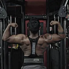 "Spread your wings." A back double biceps pose to show the width and thickness of the lat muscles, a key pose in bodybuilding.