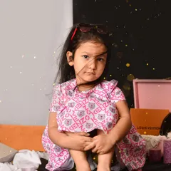 A modern, fashion-inspired portrait of a young girl. The simple two-toned background and her direct gaze create a powerful and stylish image.
