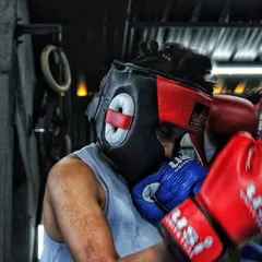 In close, this is where clinching and inside fighting skills are tested. Both boxers are wearing headgear for safety during this intense training exchange.