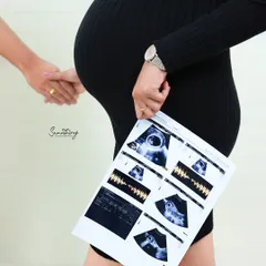A precious moment captured, with the mother-to-be holding her ultrasound scan against her growing bump. It's the first picture of a lifetime of love.