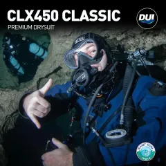 A technical diver navigates a cave wearing the DUI CLX450 Classic Drysuit. This premium suit is constructed from a trilaminate of Cordura, Butyl Rubber, and Polyester, offering unmatched durability and protection in harsh overhead environments.