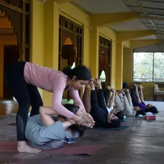 A core part of my retreats is providing hands-on, personal guidance. Here, I'm helping a student find a deeper expression in her pose during our Dehradun retreat, ensuring she feels supported and safe in her practice.