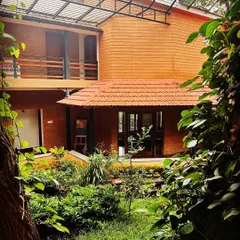 Our retreat center, seen through a frame of lush greenery. This is a place to deepen your Kriya Yoga practice and connect with the teachings of Yogananda and Swami Kriyananda.