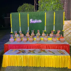 A fun and interactive setup for a 'Sanskriti' themed event. The table is filled with traditional pots and art supplies for guests to engage with.