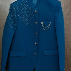 This royal blue Jodhpuri-style blazer with shoulder detailing is a modern and stylish option. It's a great rental piece for grooms or for a fashionable pre-wedding look.