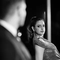 A powerful, moody portrait from a cocktail night. The bride gives an intense look over her shoulder, captured in stunning black and white.
