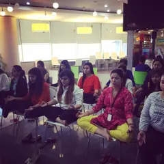 Bringing calm to the workplace is one of my passions. Here, we are practicing chair yoga and meditation during a corporate wellness session, a simple yet powerful way to reset during a busy day.