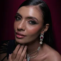 This is my signature red carpet glam. The focus is on creating luminous skin, a sharp, graphic eyeliner, and perfectly blended eyeshadow to complement the model's features and the luxurious jewelry. This look is designed to be striking both in person and in high-definition photography.