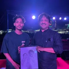 Presenting a custom portrait on stage. It's a special feeling to see my art being appreciated in public forums.