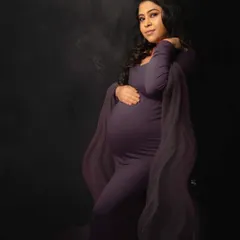 Celebrating the strength and radiance of motherhood. This mama-to-be shines in a dramatic, deep purple gown from my studio wardrobe, set against a rich, moody backdrop for a fine art feel.