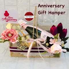 I design elegant anniversary hampers to celebrate milestones of love. This basket features a bottle of sparkling rosé, Ferrero Rocher chocolates, and champagne glasses, all presented in a stylish gold wire basket perfect for a romantic evening.
