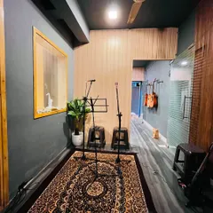 Our jamming area is set up and ready for your next practice. With microphone stands, stools, and instruments at hand, it's a professional and convenient space to perfect your craft.