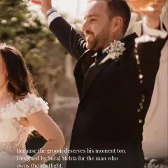 I design for the man who owns the spotlight. This image captures the joy and confidence of a groom celebrating in his bespoke black tuxedo, a testament to style that is both elegant and full of life.