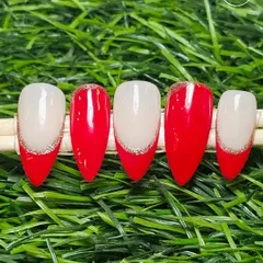 A modern take on the French manicure. This set features a classic red tip with a fine line of silver glitter for a festive and elegant touch.
