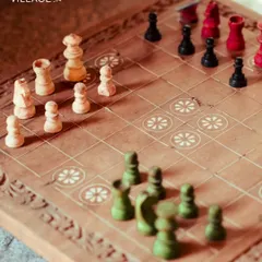 We offer a variety of traditional and modern board games, like this beautifully carved wooden chess set, perfect for a quiet afternoon of strategic thinking.