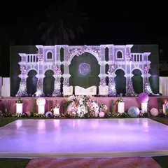 This reception stage was designed to be the romantic centerpiece of the evening. Featuring intricate white architectural details, soft floral accents, and elegant uplighting, it provided a beautiful backdrop for the couple throughout the celebration.