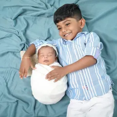 The proud big brother. Capturing the first moments between siblings is so important. The gentle way he holds his new baby sibling is just priceless.