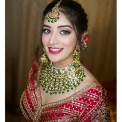 The radiance of a Punjabi bride is unmatched. I focus on creating portraits that highlight not just the stunning red lehenga and royal kundan jewelry, but also the bride's personality and joyful anticipation. This is a classic bridal portrait that celebrates heritage and elegance.