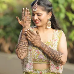 A beautiful bride-to-be, admiring her intricate bridal mehendi. Her smile says it all. It was a pleasure to be a part of her destination wedding preparations.