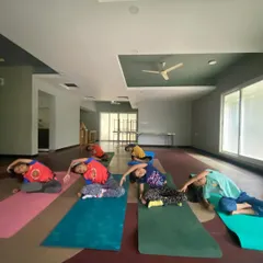 I believe in starting them young, and my kids' yoga classes are pure joy. Here you can see a group of children learning side stretches, building flexibility and body awareness through playful movement, not rigid instruction.