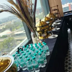 Catering with a view. We can set up a premium buffet experience in any corporate space, like this one overlooking the Bangalore cityscape. Our setup includes everything from hot main courses in our signature chafing dishes to bottled water for convenience.