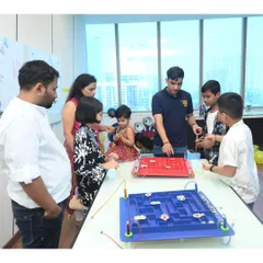 A family gathers around the maze game, cheering each other on. Our game zone becomes a natural hub for interaction and friendly competition at any event.
