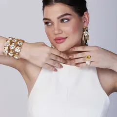 Another angle of the model showcasing the contemporary jewellery set, this time highlighting a large cocktail ring alongside the bracelet and earrings.