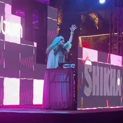 Arms up, connecting with thousands of people at Sunburn. You can feel the scale of the event in this photo, even with the blur.