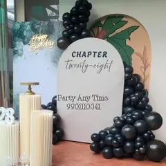 A side view of the modern birthday setup, showing the layered backdrops and balloon placement.