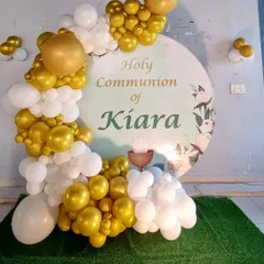 A closer look at the graceful white and gold balloon decor for the Holy Communion celebration.