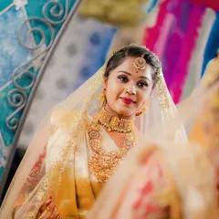 A beautiful bride admiring her final look in the mirror. My goal is to enhance your natural beauty so you feel confident and look like the best version of yourself.