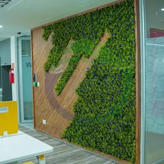 Here is a custom-framed moss wall featuring a logo cutout, blending wood and preserved moss. This is a great example of how we can integrate a company's brand directly into a biophilic art piece for a unique and memorable feature.