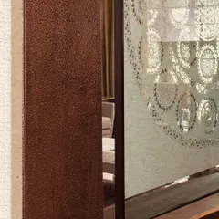 A detail from the Modi Residence showing a hammered copper panel. This highlights our use of traditional metalworking techniques to create rich, tactile surfaces in our interiors.
