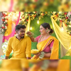 A candid moment from a Haldi ceremony, with our floral and drape backdrop adding warmth and color. We use string lights within the decor to create a soft, celebratory glow.