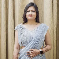 A portrait of a woman in a modern, light blue sequined saree. This is a great example of an elegant look for an event or occasion wear portfolio.
