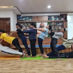 Acro Yoga is all about trusting each other. This fun group pose shows our students working together, lifting each other up, and creating a human pyramid of strength and connection.