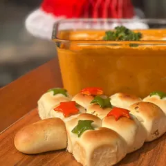Our festive pull-apart bread in the shape of a Christmas tree, served alongside our famous spinach and ricotta ravioli.