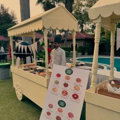 My catering carts are perfect for any outdoor event, like this poolside kids' party. The setup includes a clear menu board so everyone can see the delicious Neapolitan pizza options available.